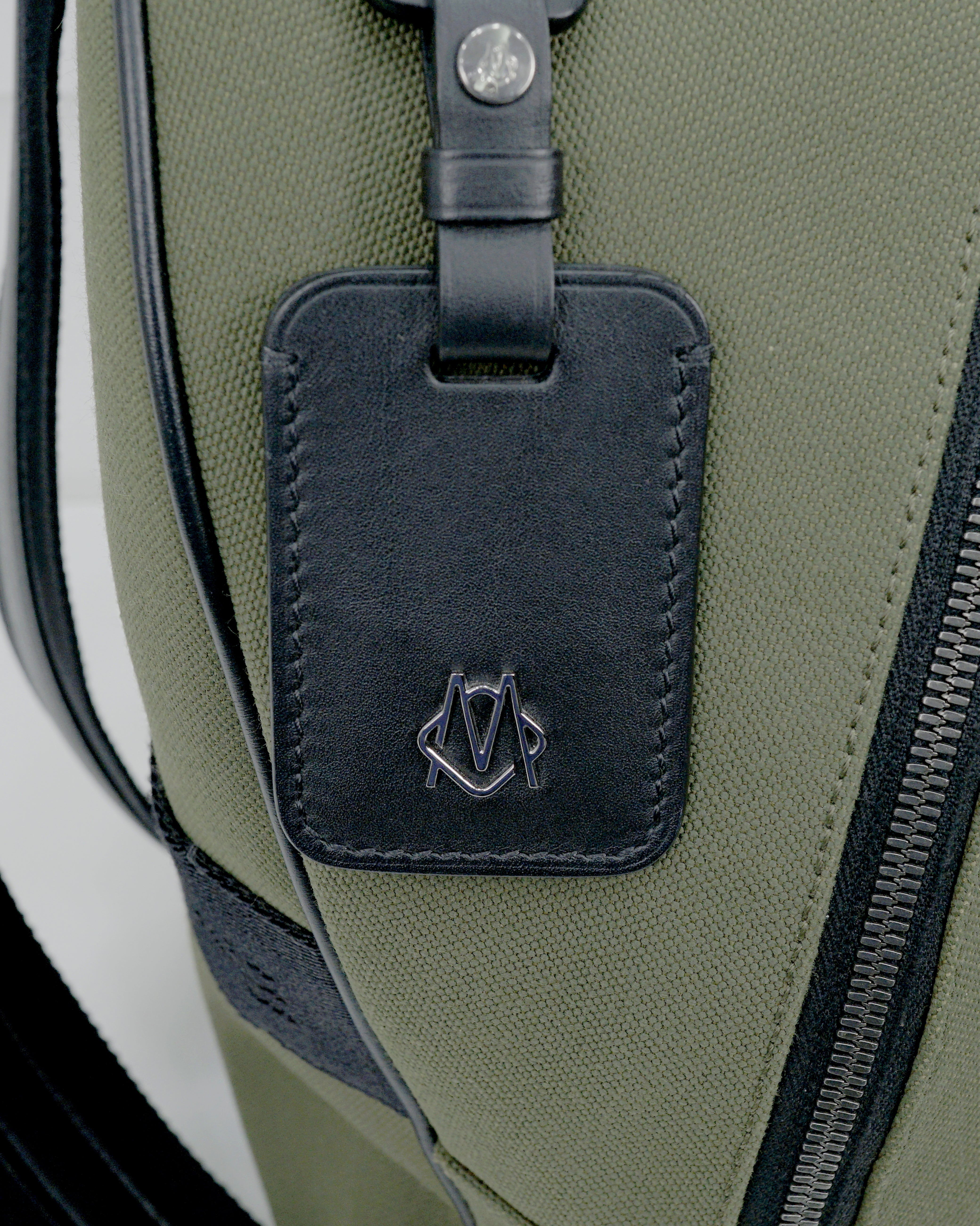 NEVER STILL BACKPACK OLIVE GREEN LEATHER-TRIMMED CANVAS